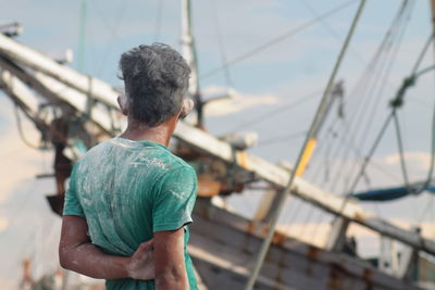 Rear view of man in boat sailing on sea