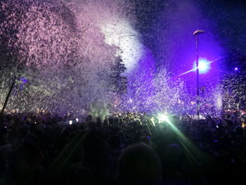 People enjoying music concert at night