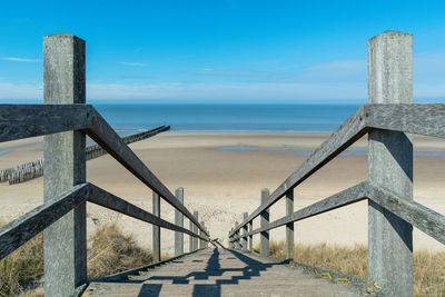 Scenic view of sea against sky with stairs