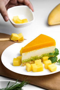 Close-up of mango sticky rice cake served on table