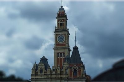 Clock tower against cloudy sky