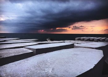 Scenic view of sea against storm clouds