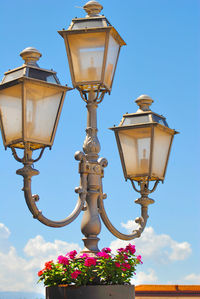 Low angle view of street light against blue sky