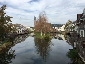 Reflection of buildings in lake against sky