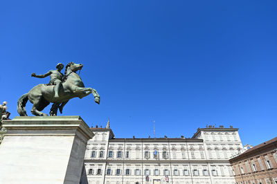 Low angle view of statue against clear blue sky