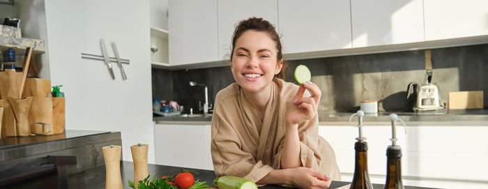 Portrait of young woman sitting at home