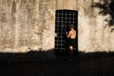 Woman standing against wall