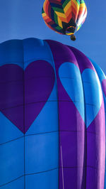 Low angle view of hot air balloon against blue sky