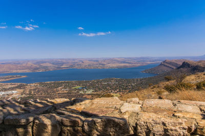 Scenic view of landscape against blue sky