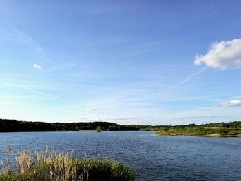 Scenic view of lake against blue sky