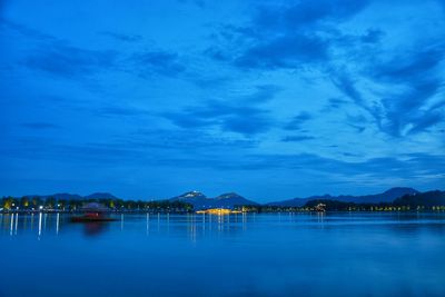 Scenic view of west lake against sky at night