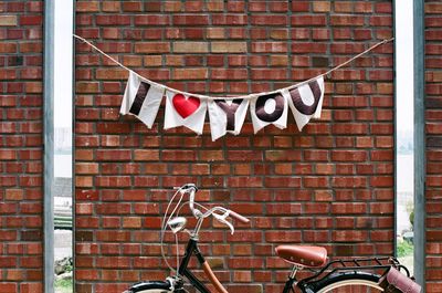 Bicycle sign on brick wall