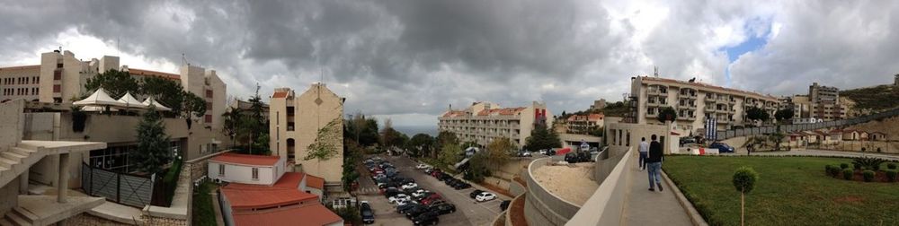 Buildings against cloudy sky