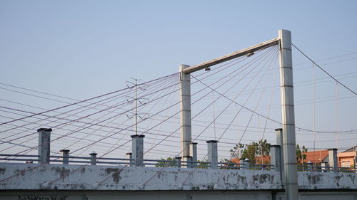 Low angle view of suspension bridge against clear sky in semarang, indonesia