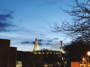 Low angle view of illuminated bridge against sky at night