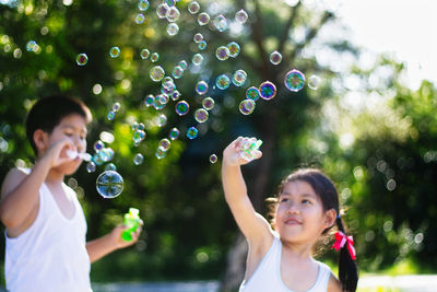 Happy girl with bubbles in mid-air