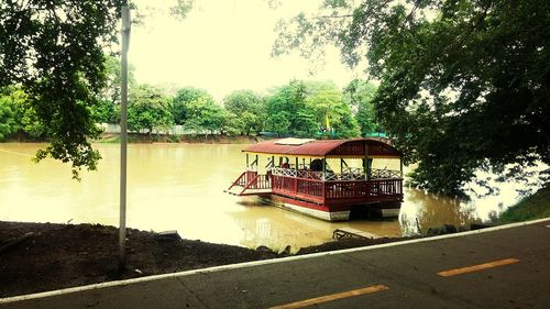 Gazebo by lake against sky