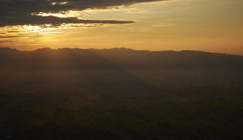 Scenic view of landscape against sky during sunset