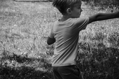 Full length of boy standing on field