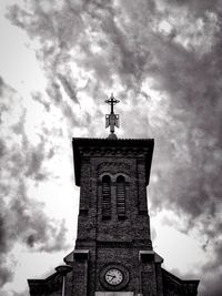 Low angle view of weather bell tower against sky
