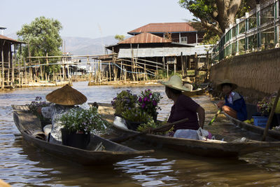 Boats in river with buildings in background