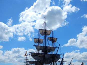 Low angle view of windmill against blue sky