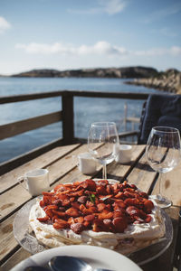 Meringue with strawberries on table