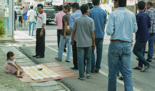 Rear view of people walking outdoors