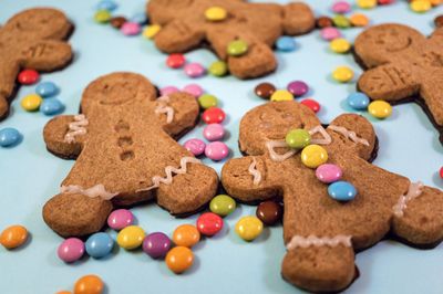 Close-up of decorated gingerbread man cookies on a blue background 