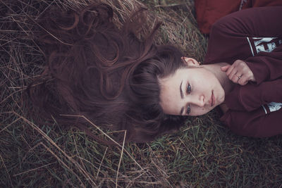 High angle portrait of woman relaxing on field