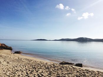 Scenic view of beach against blue sky