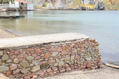 View of stone wall by river