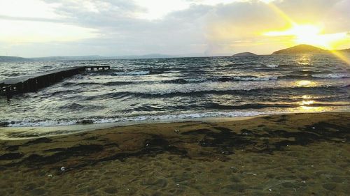 Scenic view of beach against sky during sunset