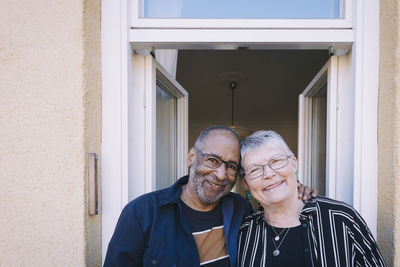 Smiling senior couple in balcony at home