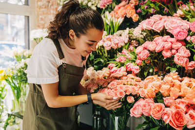 Florist analyzing flowers at shop