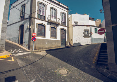 Road by buildings in city