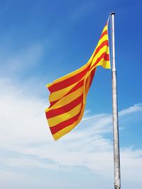 Low angle view of spanish flag against sky