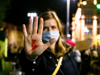 Woman has drawn a sign lightning on hand. women protest against tightening of abortion law. poland.