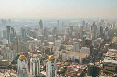 High angle view of modern buildings in city against sky