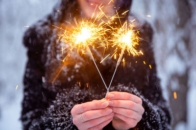 Close-up of hand holding sparkler