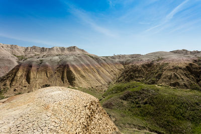 Scenic view of rocky mountains against blue sky