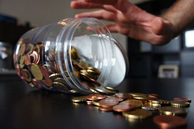 Close-up of hands by jar