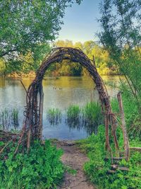 Arch bridge over lake against sky