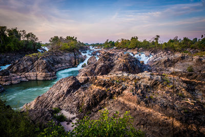 Scenic view of rocks in sea against sky