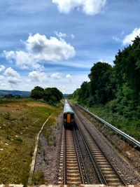 Train on railway track against sky