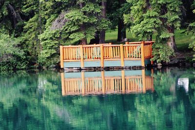 Built structure in lake against trees in forest