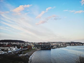 High angle view of river by buildings against sky