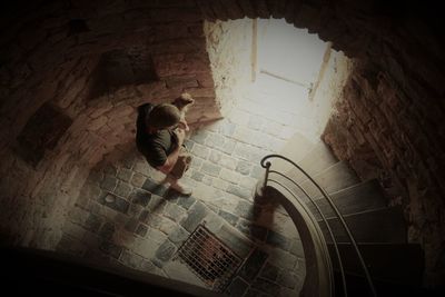 High angle view of woman walking up stairs
