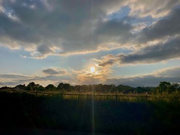 Scenic view of field against sky during sunset