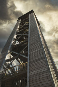 Low angle view of bridge against cloudy sky